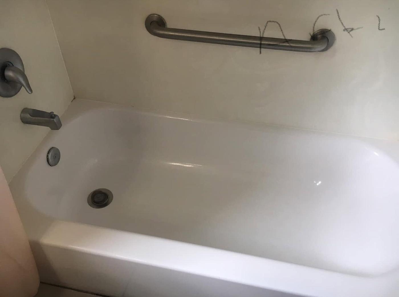 Tub with a grab bar, after we cleaned it